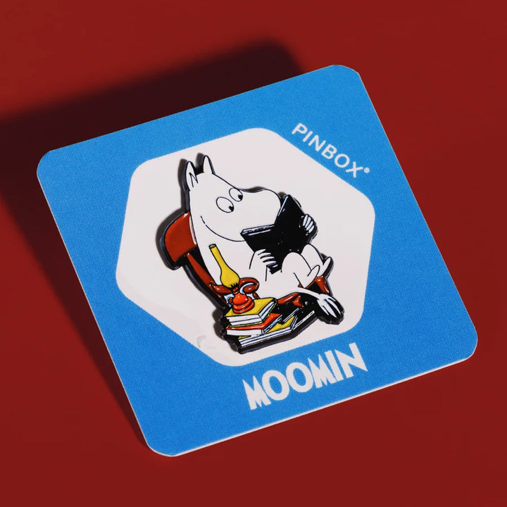 Moomintroll reading a book